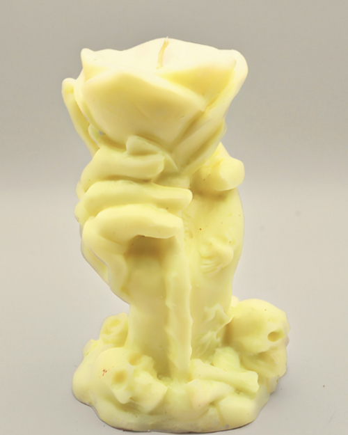 Yellow candle shaped like a hand with a rose on a gray background