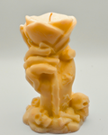 Amber orange hand & Rose Candle on a light gray background