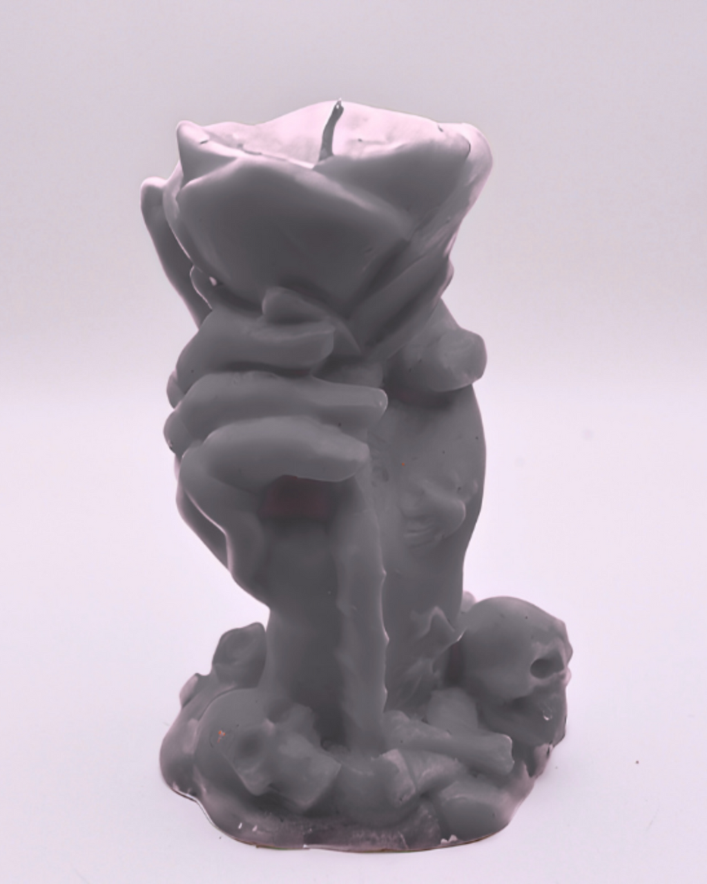 Gray candle of a hand holding a rose on a white background