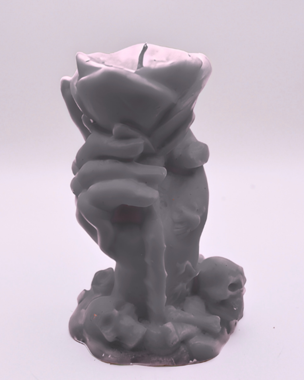 Gray candle of a hand holding a rose on a white background