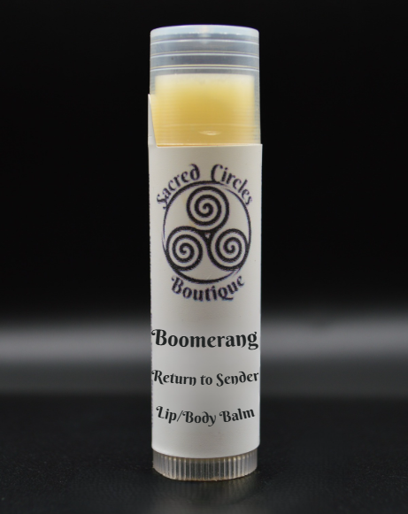 Lip/body balm stick labeled 'Boomerang' with 'Sacred Circle Boutique' logo on a black background