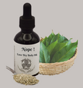 Bottle of 'Nope!' Luxe Dry Body Oil with a dropper, surrounded by green leaves and dried herbs on a gray background.