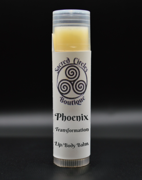 Lip/body balm stick labeled 'Phoenix' with 'Sacred Circle Boutique' logo on a black background